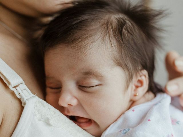 A newborn asleep on a mother’s chest