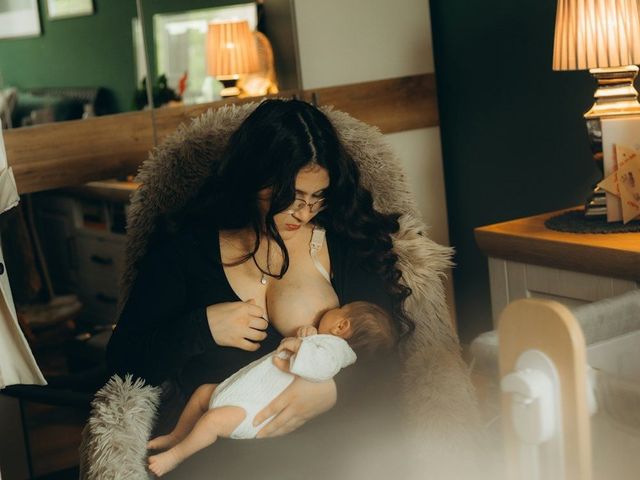 A mother feeding her baby in a cosy room