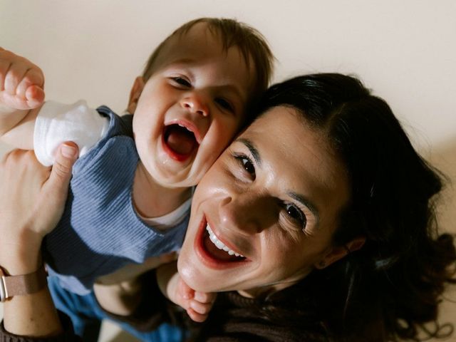 A mother laughing with her baby