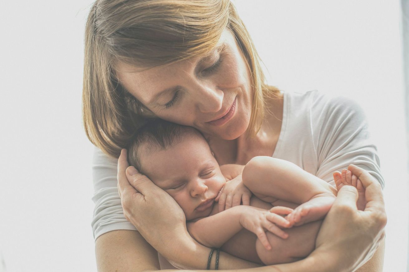 A mother holding her newborn skin to skin