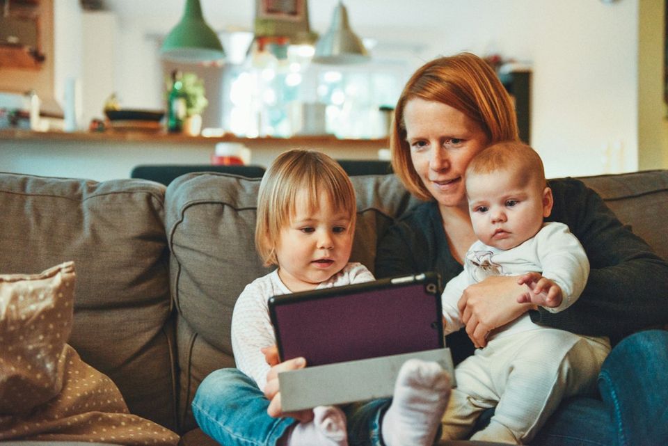 A mother at home with her two small children